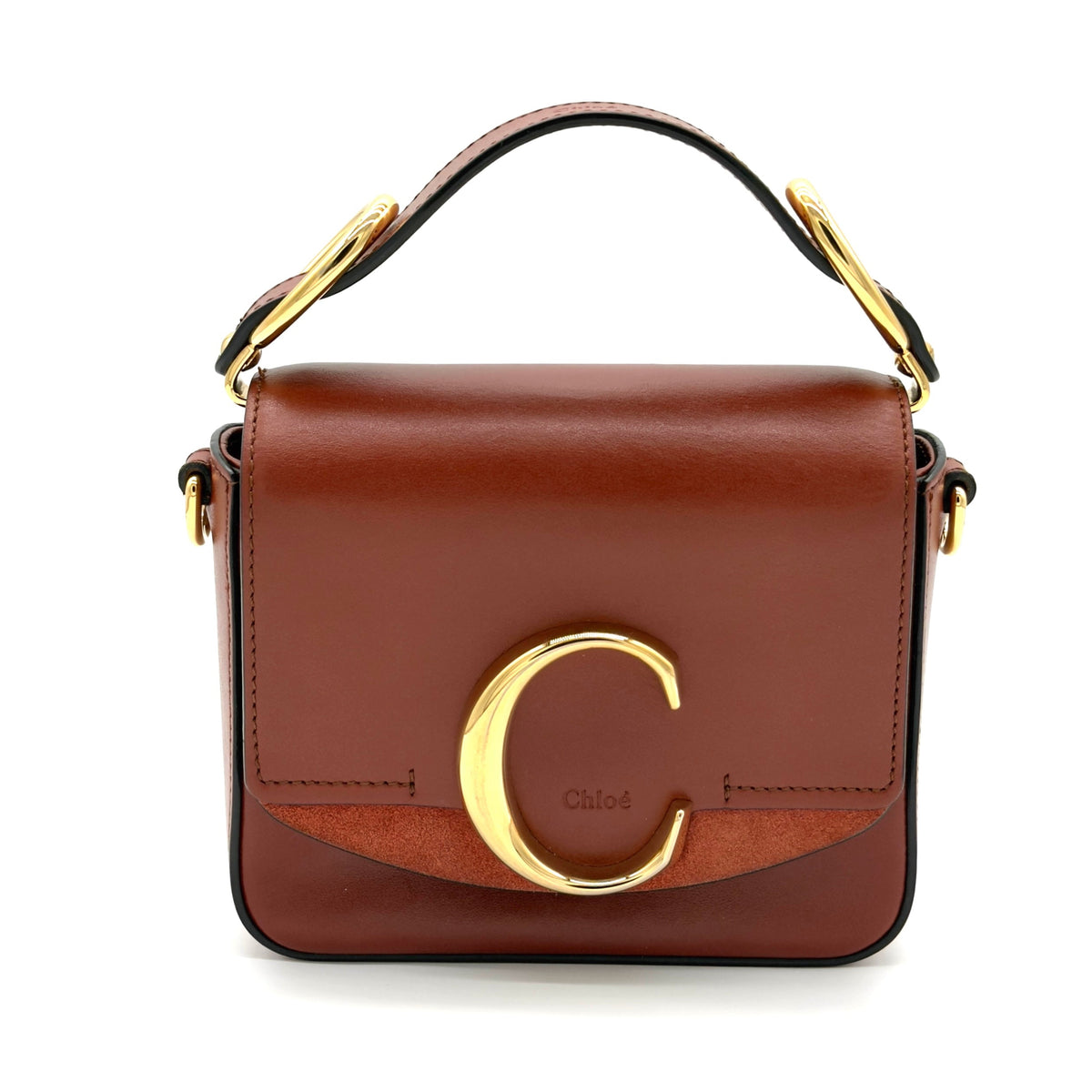 Brown handbag with gold accents on a white background