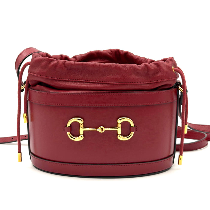 Maroon handbag with gold clasp on a white background