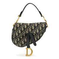 Designer handbag with monogram pattern and gold hardware on a white background