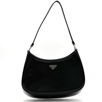 Black handbag with Prada logo on a white background