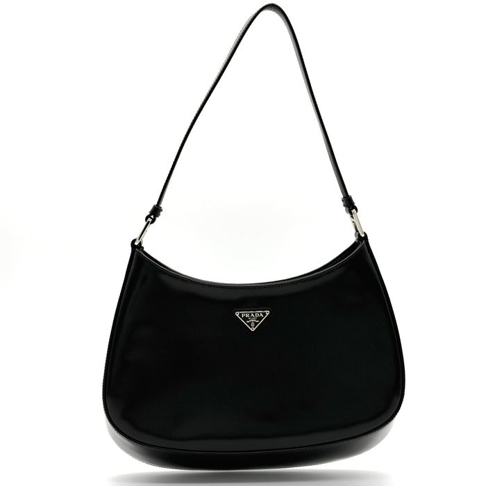 Black handbag with Prada logo on a white background