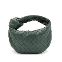Green woven handbag on a white background