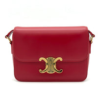 Red handbag with a gold clasp on a white background