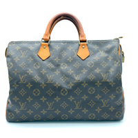 Designer handbag with monogram pattern on a white background