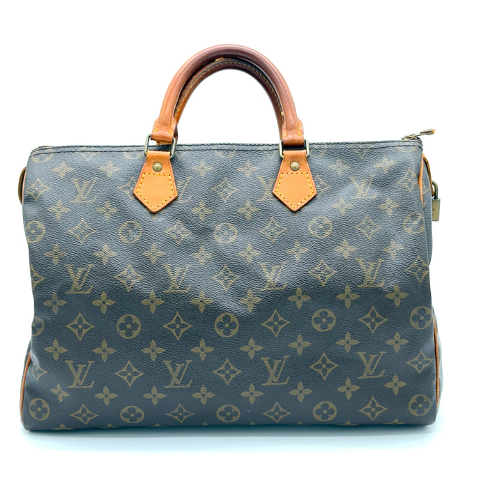 Designer handbag with monogram pattern on a white background