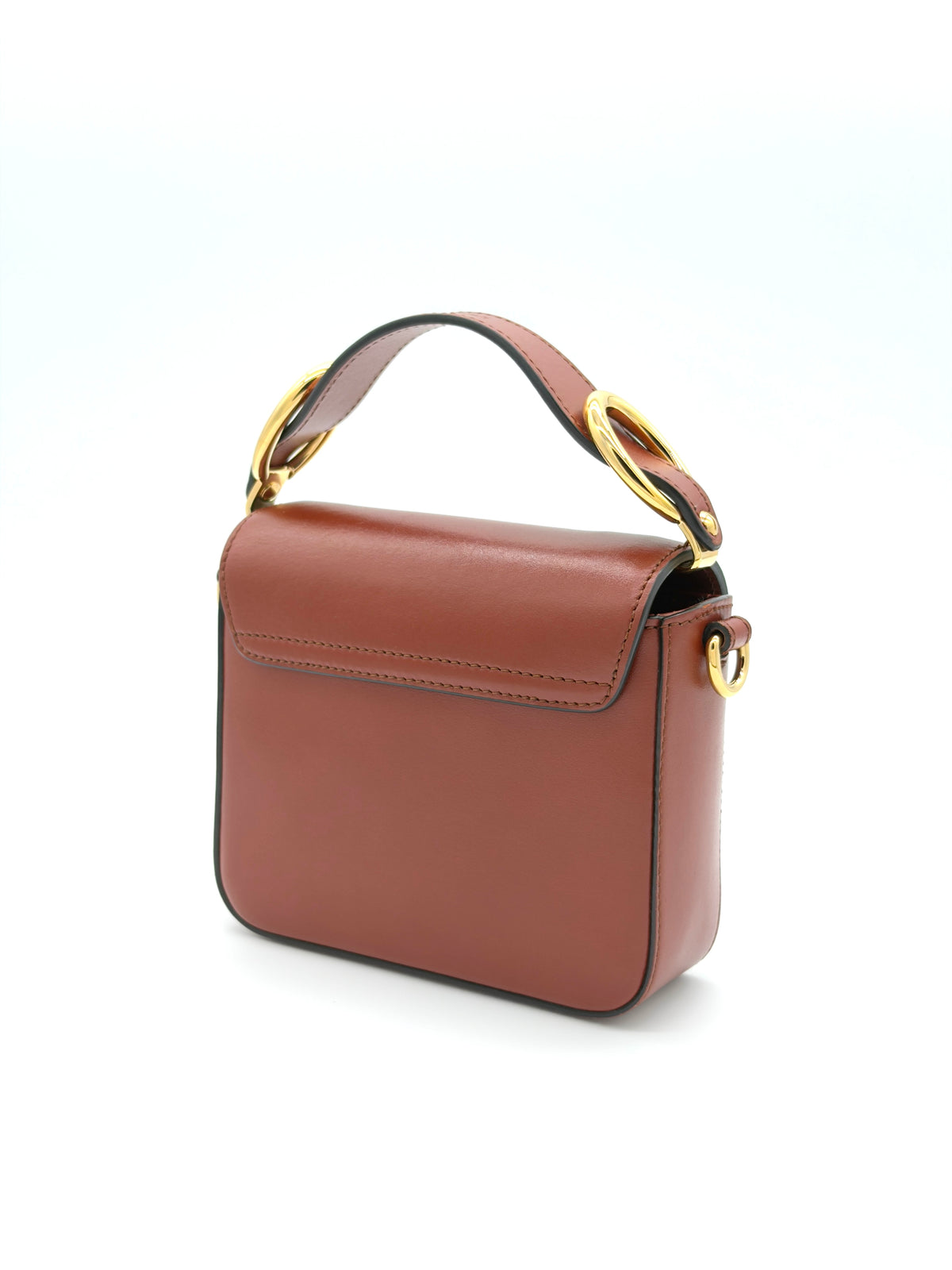 Brown leather handbag with gold accents on a white background