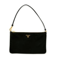 Black handbag with gold accents on a white background