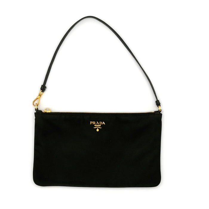 Black handbag with gold accents on a white background